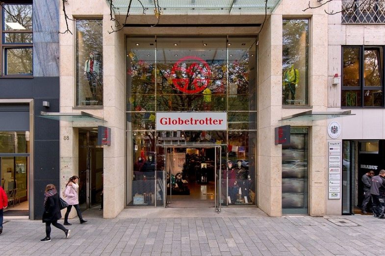 Königsallee 88 detail of glass front store Globetrotter with pedestrians walking along